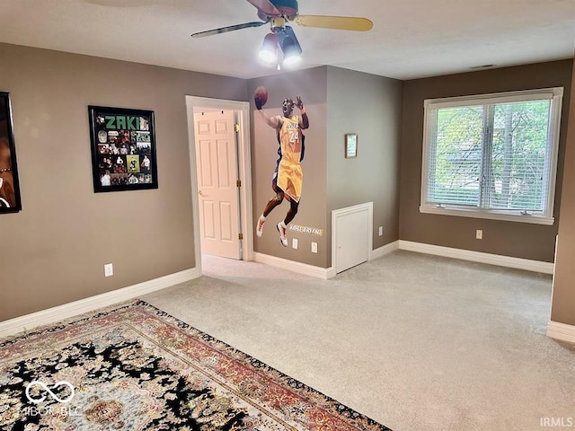 unfurnished room featuring light colored carpet and ceiling fan