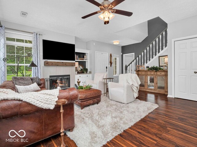 living room with ceiling fan and hardwood / wood-style flooring