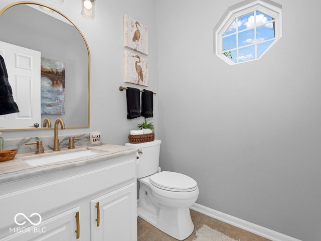 bathroom featuring tile patterned floors, toilet, and vanity