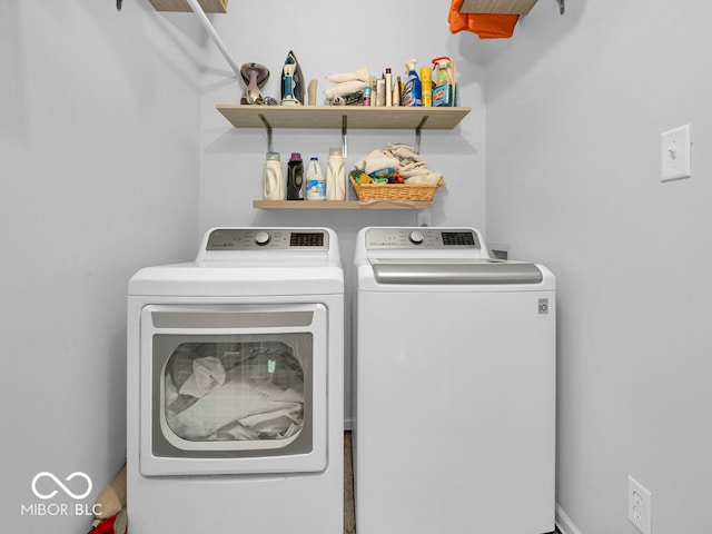 laundry area with washing machine and clothes dryer