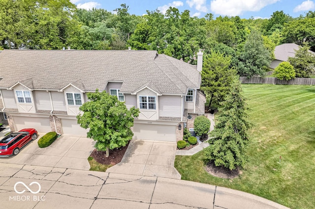 view of front facade with a garage and a front lawn