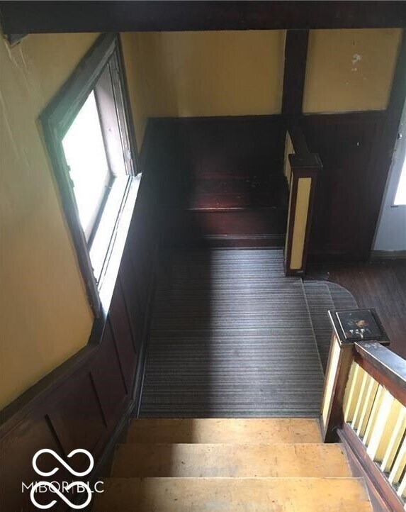 3358 Ruckle St, Indianapolis, IN 46205 - staircase featuring hardwood / wood-style floors
