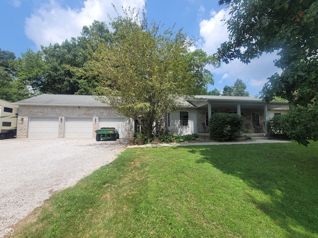 ranch-style house featuring a garage and a front lawn