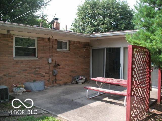 rear view of house with a patio and central AC