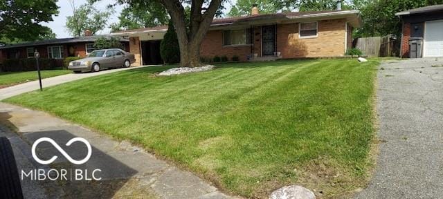 ranch-style home with a front lawn