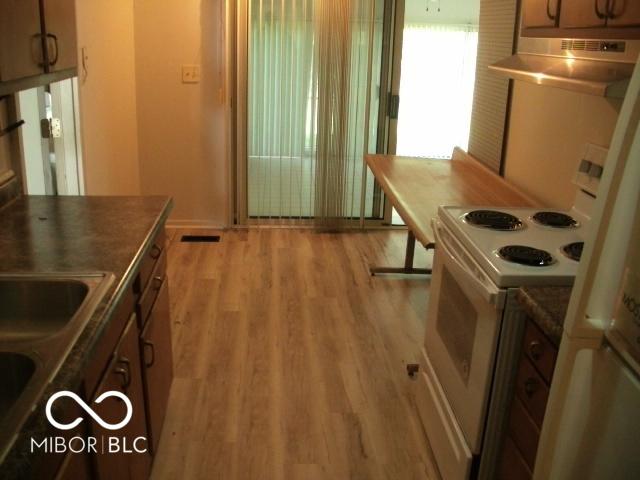 kitchen featuring sink, white electric range, and light hardwood / wood-style flooring