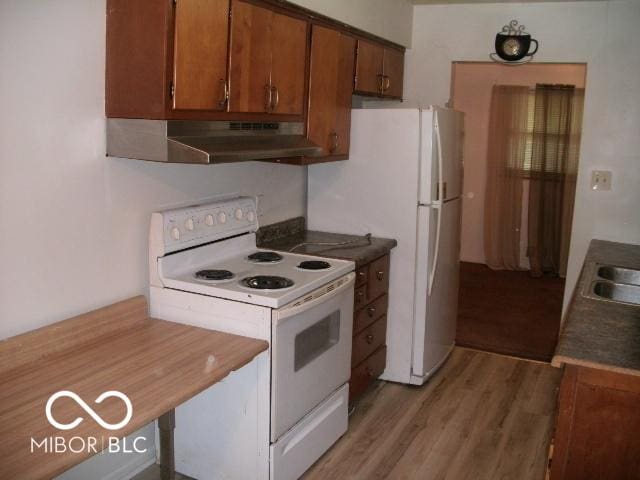 kitchen with white appliances and wood-type flooring