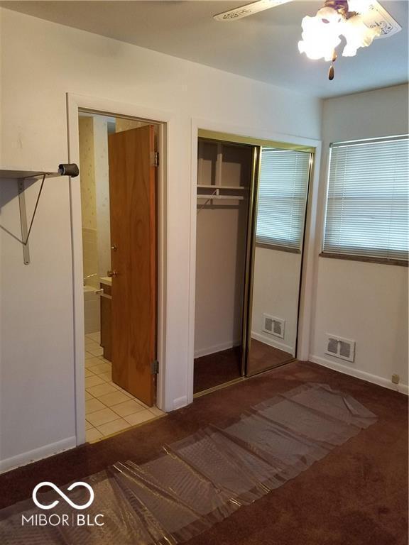 unfurnished bedroom with tile patterned flooring and ceiling fan