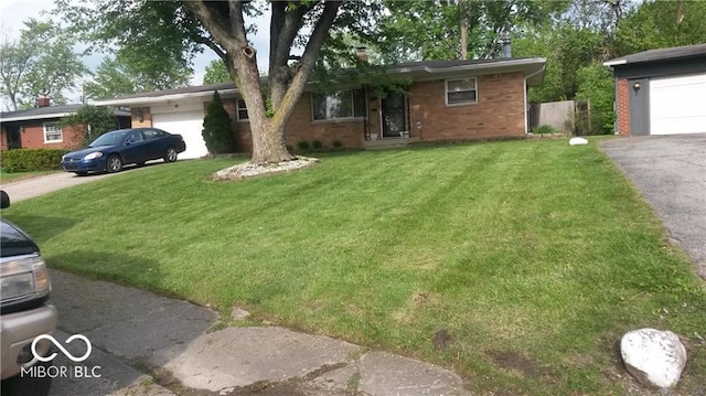 single story home with a garage and a front lawn