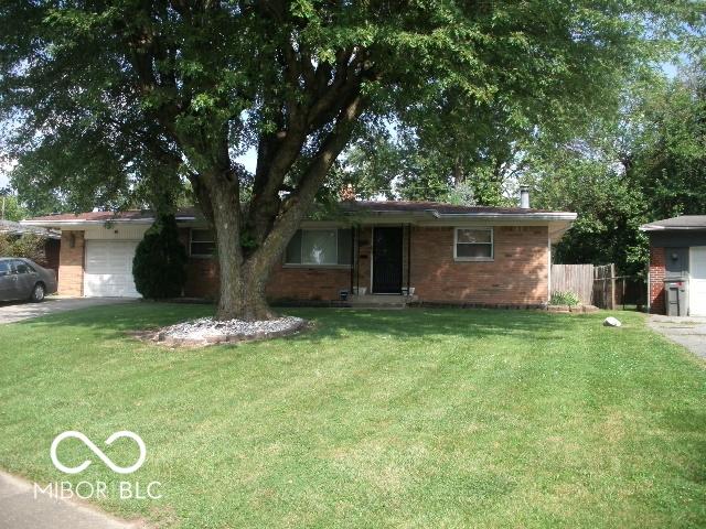 single story home with a garage and a front yard