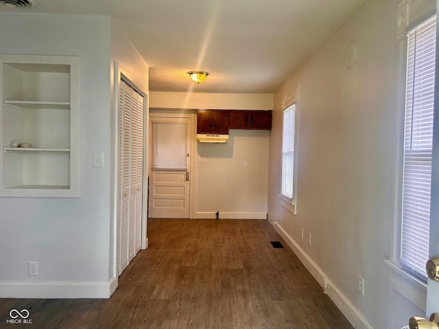 corridor with dark hardwood / wood-style floors