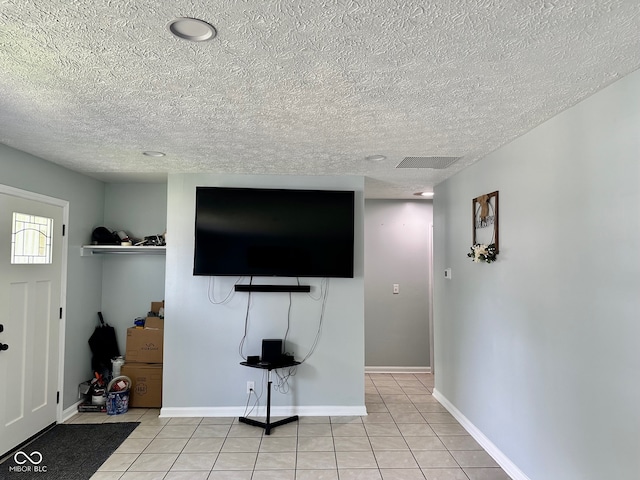 living room with light tile patterned floors and a textured ceiling