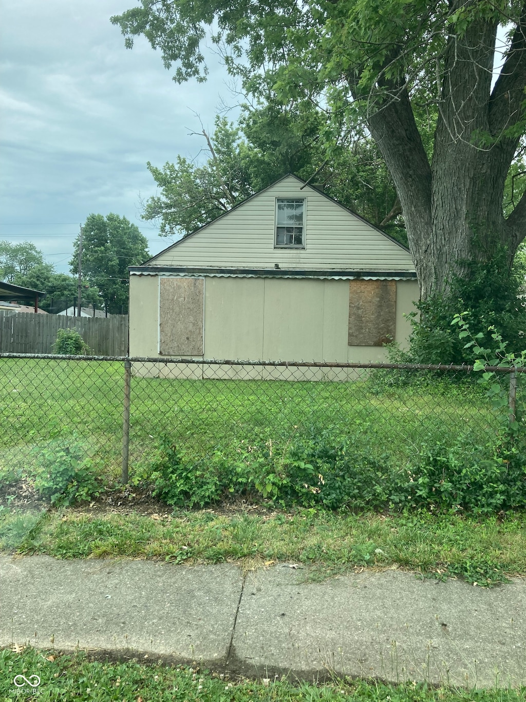 view of side of home featuring a lawn