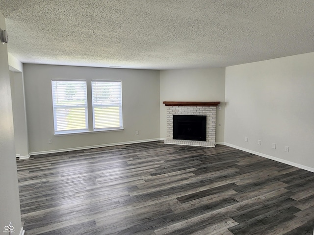 unfurnished living room featuring dark hardwood / wood-style flooring, a fireplace, and a textured ceiling