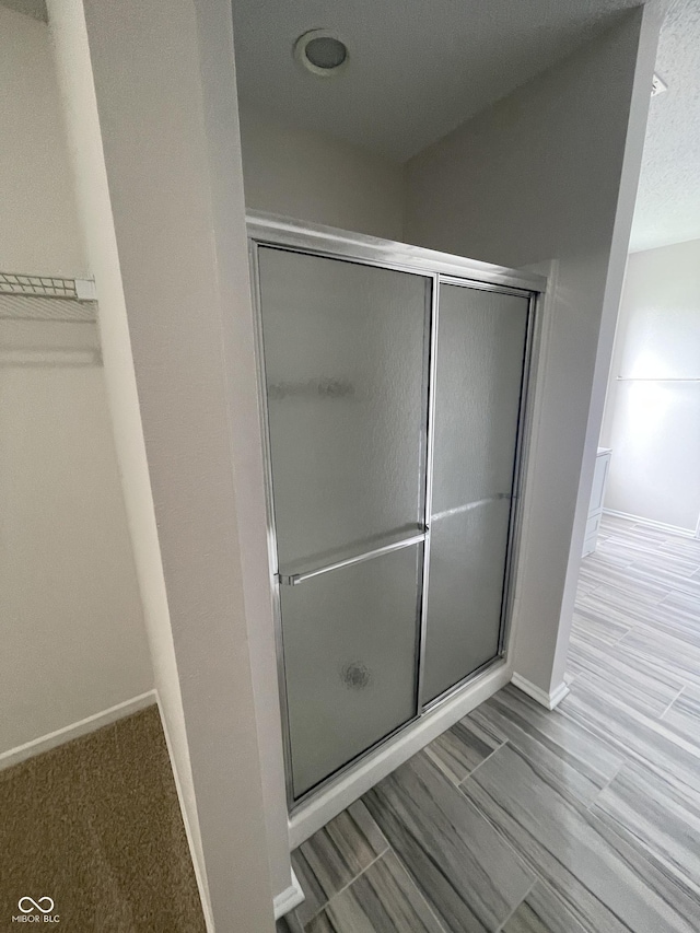 bathroom featuring an enclosed shower