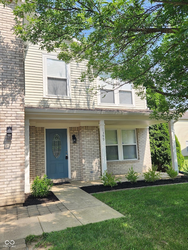 view of front of property with a front yard and covered porch