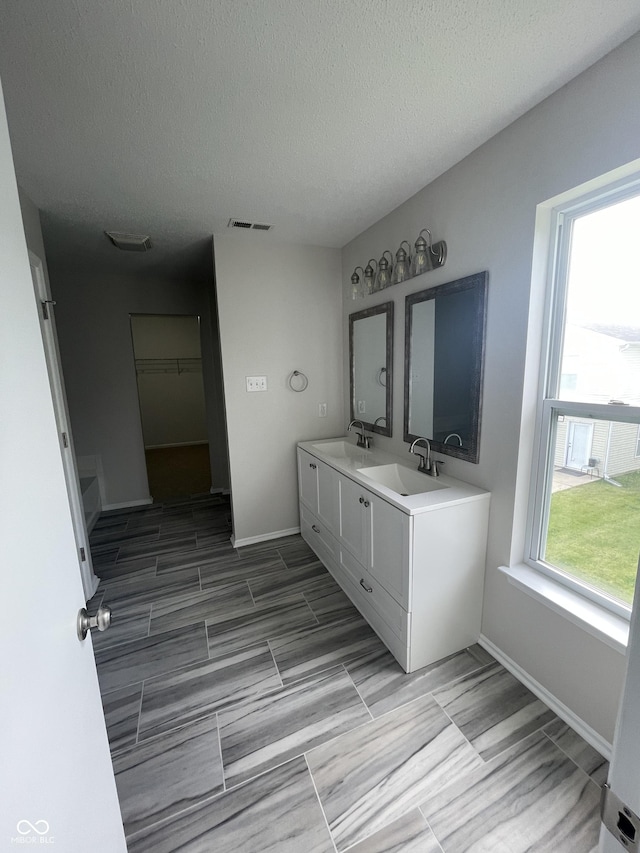 bathroom with vanity and a textured ceiling