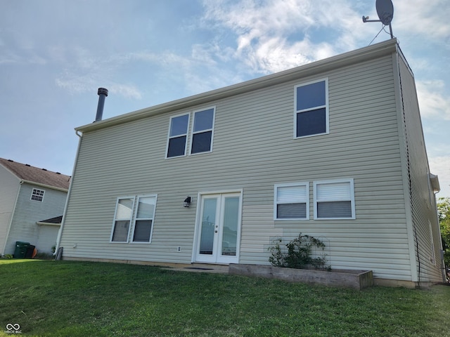 back of property with a lawn and french doors