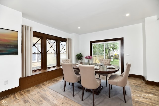 dining space featuring wood-type flooring