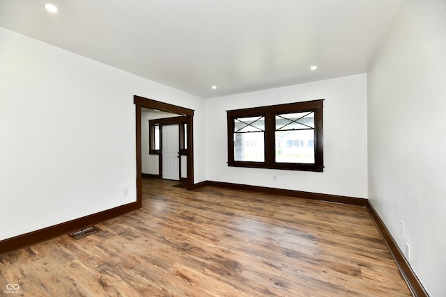 empty room with hardwood / wood-style floors