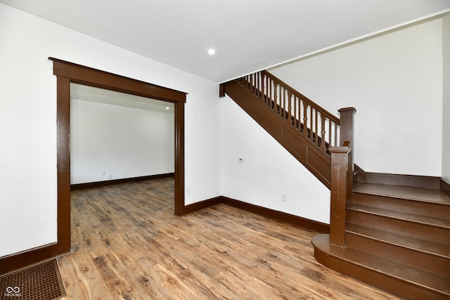 stairway with hardwood / wood-style floors