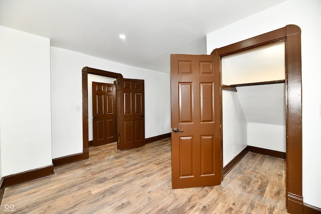 bedroom featuring light hardwood / wood-style floors and a closet