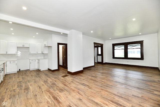 unfurnished living room featuring hardwood / wood-style flooring