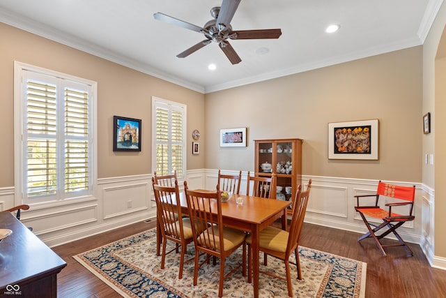 dining room with crown molding, dark wood-type flooring, plenty of natural light, and ceiling fan