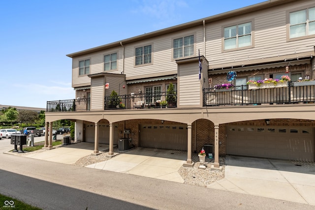 view of property with a garage and a balcony