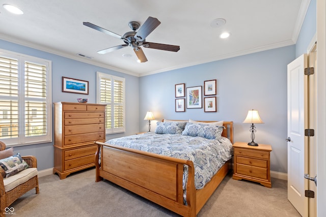 bedroom with ornamental molding, light colored carpet, and ceiling fan