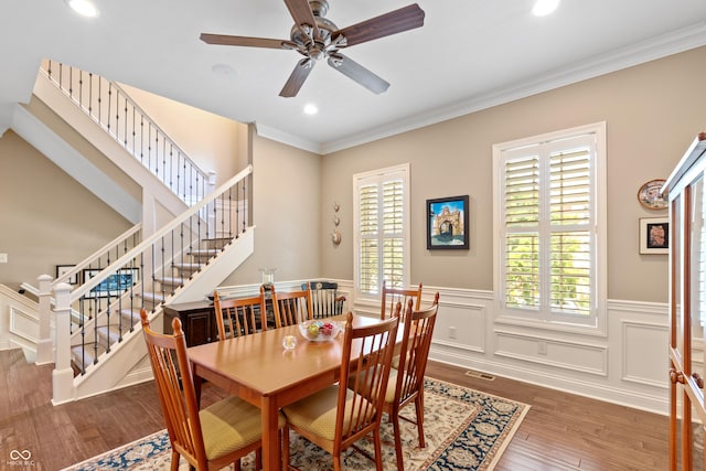 dining room with ornamental molding, dark hardwood / wood-style floors, and ceiling fan