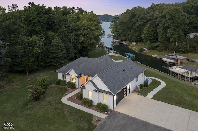 aerial view at dusk with a water view