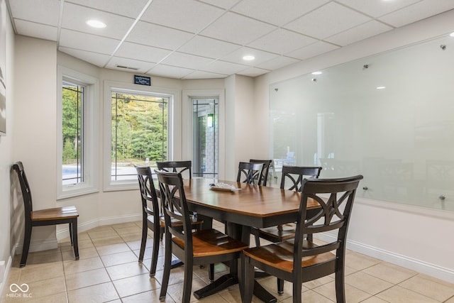 dining room featuring a paneled ceiling and light tile patterned floors