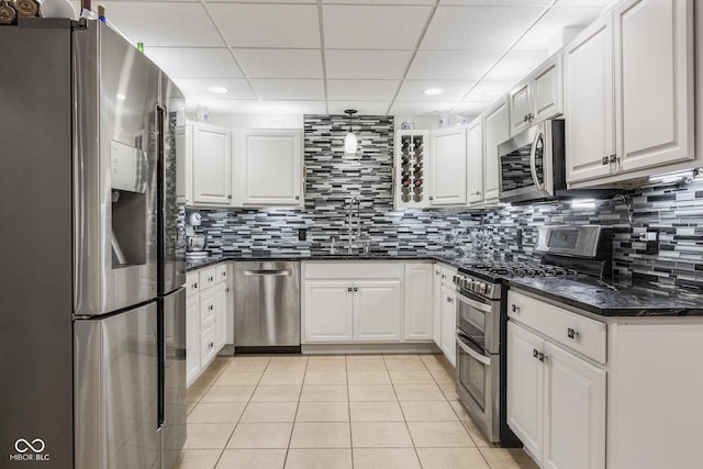 kitchen with appliances with stainless steel finishes, sink, and white cabinets