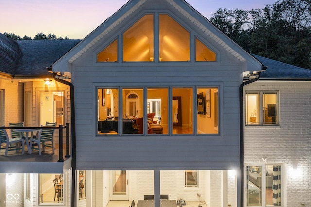 back house at dusk with a patio