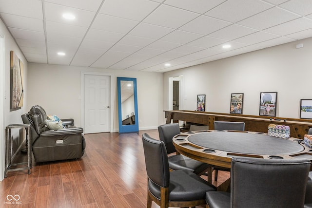 dining space featuring a paneled ceiling and wood-type flooring