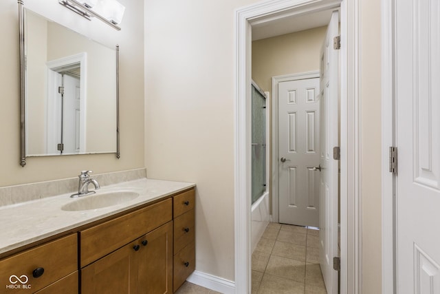 bathroom featuring enclosed tub / shower combo, vanity, and tile patterned flooring