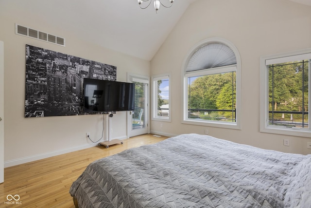 bedroom featuring high vaulted ceiling and light wood-type flooring