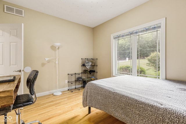 bedroom with wood-type flooring