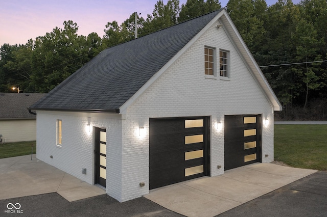 view of garage at dusk