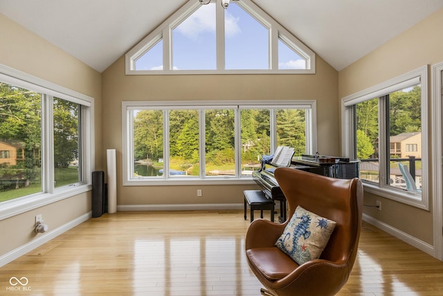 sunroom / solarium with lofted ceiling and a healthy amount of sunlight