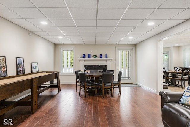 dining area featuring plenty of natural light, dark hardwood / wood-style floors, and a fireplace