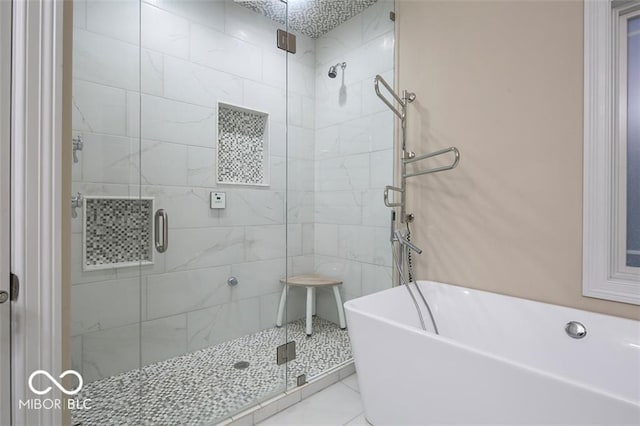 bathroom featuring tile patterned flooring and independent shower and bath