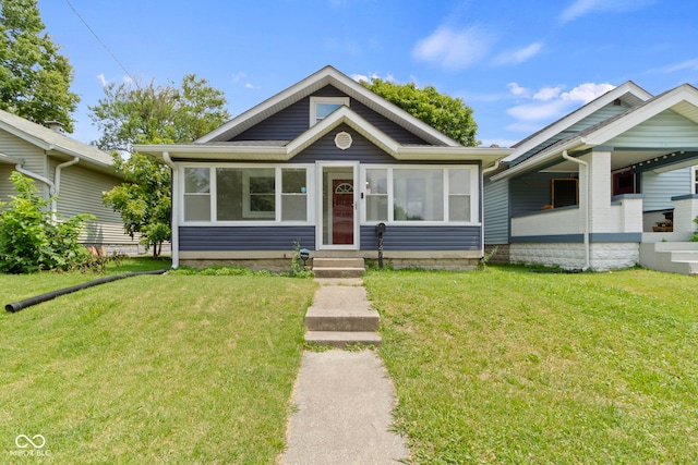 bungalow-style house with a front lawn