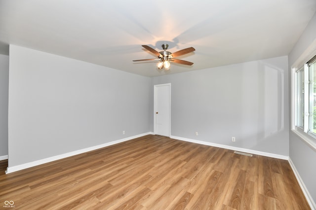 empty room featuring ceiling fan and light hardwood / wood-style floors