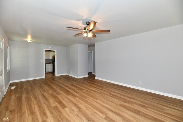 unfurnished living room featuring light wood-type flooring and ceiling fan