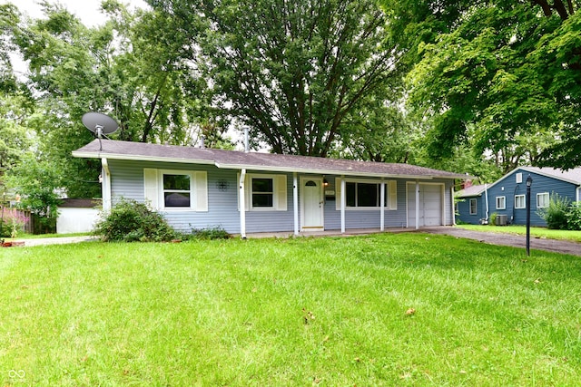 ranch-style house featuring a porch, a garage, and a front yard