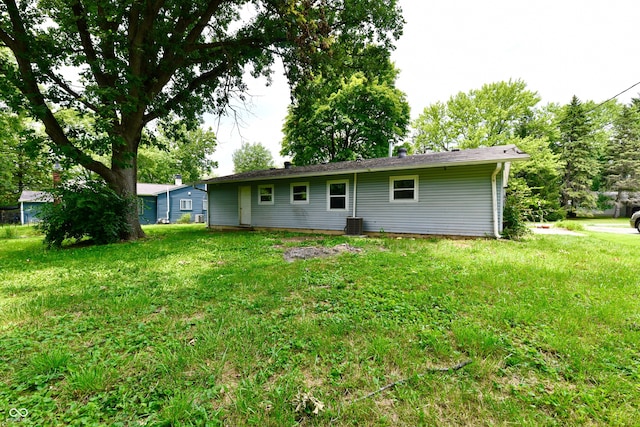 rear view of property featuring a lawn