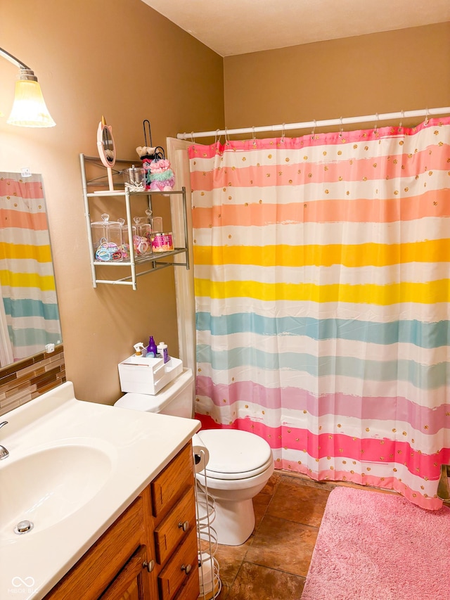 bathroom with tile patterned flooring, a shower with shower curtain, vanity, and toilet