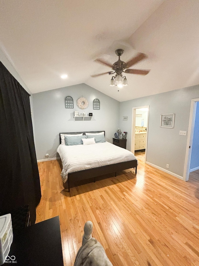 bedroom with vaulted ceiling, light wood-style flooring, baseboards, and ceiling fan